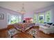 Charming main bedroom featuring bay windows, hardwood floors, a chandelier, and ample natural light at 1195 Framptons Inlet Rd, Edisto Island, SC 29438