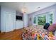 Comfortable main bedroom with hardwood floors, bay windows, and closet space with a chandelier at 1195 Framptons Inlet Rd, Edisto Island, SC 29438