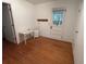 A bonus room with wood flooring, an exterior door, and a small table at 1195 Framptons Inlet Rd, Edisto Island, SC 29438