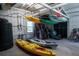 Spacious storage area with kayaks, water tanks and outdoor equipment at 1195 Framptons Inlet Rd, Edisto Island, SC 29438