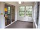 Bright sunroom featuring multiple windows, a ceiling fan and sliding glass door to the screened porch at 1195 Framptons Inlet Rd, Edisto Island, SC 29438