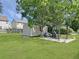 Spacious backyard with a large tree providing shade over a pergola, shed, and a well-maintained lawn at 1207 Saint Johns Ave, Moncks Corner, SC 29461