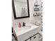 Bathroom featuring a modern vanity with black hardware, a dark framed mirror and floating shelves at 1207 Saint Johns Ave, Moncks Corner, SC 29461