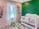 Bright Bedroom with pink and green accent walls, and a view from the large window at 1207 Saint Johns Ave, Moncks Corner, SC 29461