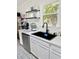 Modern kitchen sink with stainless steel appliances, white cabinets and stylish backsplash at 1207 Saint Johns Ave, Moncks Corner, SC 29461