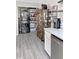 Efficient laundry area in the kitchen includes stackable washer/dryer and built in shelving for storage of supplies at 1207 Saint Johns Ave, Moncks Corner, SC 29461