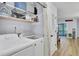 Functional laundry room with modern washer and dryer, ample storage, and easy access to the porch at 1208 Village Creek Ln Ln # 1, Mount Pleasant, SC 29464
