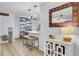 Open concept living space features a modern shelving unit, bar seating, and a decorative mirror at 1208 Village Creek Ln Ln # 1, Mount Pleasant, SC 29464