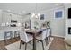 Bright dining area next to kitchen, featuring a modern chandelier and plenty of seating at 121 Brown Swiss Cir, Summerville, SC 29483