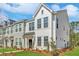 Charming new construction townhome with light siding, lovely landscaping, and a welcoming front entrance at 121 Brown Swiss Cir, Summerville, SC 29483