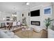 Open-concept living and dining area with a modern fireplace and ample natural light at 121 Brown Swiss Cir, Summerville, SC 29483