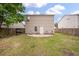 Backyard featuring a small gravel patio with chairs and a fenced-in yard at 1219 Bradley Blvd, Summerville, SC 29486