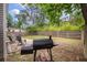 Backyard featuring a small gravel patio with chairs, BBQ grill and a fenced-in yard at 1219 Bradley Blvd, Summerville, SC 29486
