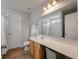 Bathroom with wood-look flooring, a large mirror and cabinets under a solid surface counter at 1219 Bradley Blvd, Summerville, SC 29486