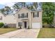 Charming two-story home features a classic design with black shutters and a well-maintained front yard at 1219 Bradley Blvd, Summerville, SC 29486