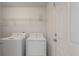 Functional laundry room with modern washer and dryer, and storage shelves at 1219 Bradley Blvd, Summerville, SC 29486
