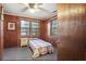 Bedroom featuring wood paneling, ceiling fan, and natural light at 1263 N Highway 52, Moncks Corner, SC 29461
