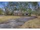 Quaint brick home with a long driveway and well-maintained lawn, set back from the road at 1263 N Highway 52, Moncks Corner, SC 29461
