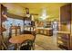 Spacious eat-in kitchen combines cooking and dining with wood cabinets, a bright window, and cozy rug at 1263 N Highway 52, Moncks Corner, SC 29461