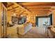 Expansive living room features wood paneling, beamed ceilings, and a brick fireplace for cozy gatherings at 1263 N Highway 52, Moncks Corner, SC 29461