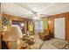 Charming living room with wood paneling, patterned ceiling, comfortable seating, and a cozy atmosphere at 1263 N Highway 52, Moncks Corner, SC 29461