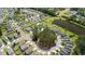 Expansive aerial view of a suburban neighborhood featuring well-maintained lawns and a community pond at 160 Brookhaven Rd, Summerville, SC 29486