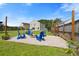 Backyard featuring a fire pit with Adirondack chairs, string lights, and lush green lawn at 160 Brookhaven Rd, Summerville, SC 29486