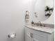 Stylish powder room with a marble vanity, round mirror, and decorative shelving at 160 Brookhaven Rd, Summerville, SC 29486