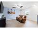 Spacious bonus room featuring a cozy couch, guitars on the wall and a ceiling fan at 160 Brookhaven Rd, Summerville, SC 29486