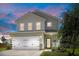 Two-story home featuring attached garage, manicured lawn, landscaping, and charming front porch with seating at 160 Brookhaven Rd, Summerville, SC 29486