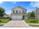 Charming two-story home with a two-car garage, manicured lawn, and a welcoming front porch seating area at 160 Brookhaven Rd, Summerville, SC 29486