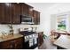 Close-up of a gourmet kitchen featuring stainless steel appliances, granite countertops, and wooden cabinets at 160 Brookhaven Rd, Summerville, SC 29486