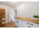 Well-lit laundry room has butcher block countertops, white cabinets, and storage shelves at 160 Brookhaven Rd, Summerville, SC 29486