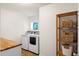Functional laundry room includes side-by-side washer and dryer, butcher block countertop, and shelf at 160 Brookhaven Rd, Summerville, SC 29486