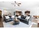 Spacious living room with dark sofas, ceiling fan, an open layout, and hardwood floors at 160 Brookhaven Rd, Summerville, SC 29486
