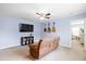 Cozy living room features a brown reclining sofa, guitars on the wall, TV, and neutral carpet at 160 Brookhaven Rd, Summerville, SC 29486
