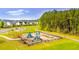 Community playground with slides and swings with a walking path behind the playground in Cane Bay at 160 Brookhaven Rd, Summerville, SC 29486