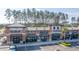Exterior of the shopping center featuring multiple business storefronts, parking, and palm trees at 160 Brookhaven Rd, Summerville, SC 29486