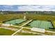 A high-angle captures the Cane Bay tennis courts with a backdrop of lush trees at 160 Brookhaven Rd, Summerville, SC 29486