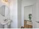 Charming half bathroom with a pedestal sink, round mirror, and neutral decor at 175 Darby Meadow Ln, Ridgeville, SC 29472
