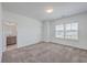 Comfortable bedroom with neutral carpet, a window overlooking the yard, and an ensuite bathroom at 175 Darby Meadow Ln, Ridgeville, SC 29472