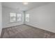 Clean bedroom with neutral carpet and two windows providing ample natural light at 175 Darby Meadow Ln, Ridgeville, SC 29472