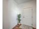 Bright entryway with wood-look flooring, a white door, and a decorative potted plant at 175 Darby Meadow Ln, Ridgeville, SC 29472