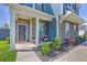 Charming front porch with stone accents, seating, and landscaped garden bed, exuding curb appeal at 175 Darby Meadow Ln, Ridgeville, SC 29472