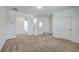 Open hallway with neutral carpet offers access to various rooms, providing a seamless flow at 175 Darby Meadow Ln, Ridgeville, SC 29472