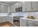 Stylish kitchen featuring gray cabinets, stainless steel appliances, and subway tile backsplash at 175 Darby Meadow Ln, Ridgeville, SC 29472