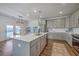 Bright, open kitchen with stainless steel appliances, a large island, and stylish pendant lighting at 175 Darby Meadow Ln, Ridgeville, SC 29472