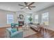 Bright living room with hardwood floors, fireplace, large windows, and comfortable seating area at 175 Darby Meadow Ln, Ridgeville, SC 29472