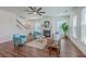 Cozy living room with fireplace, hardwood floors, comfortable seating, and plenty of natural light at 175 Darby Meadow Ln, Ridgeville, SC 29472