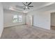 Spacious main bedroom features a tray ceiling with a fan, large window, and an ensuite bath at 175 Darby Meadow Ln, Ridgeville, SC 29472